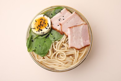 Photo of Delicious ramen with meat on beige background, top view. Noodle soup