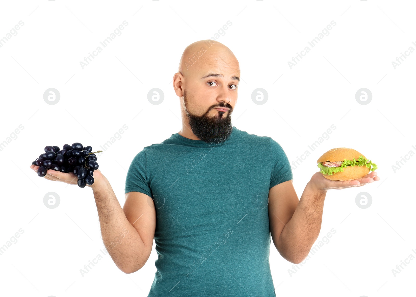 Photo of Overweight man with hamburger and grapes on white background