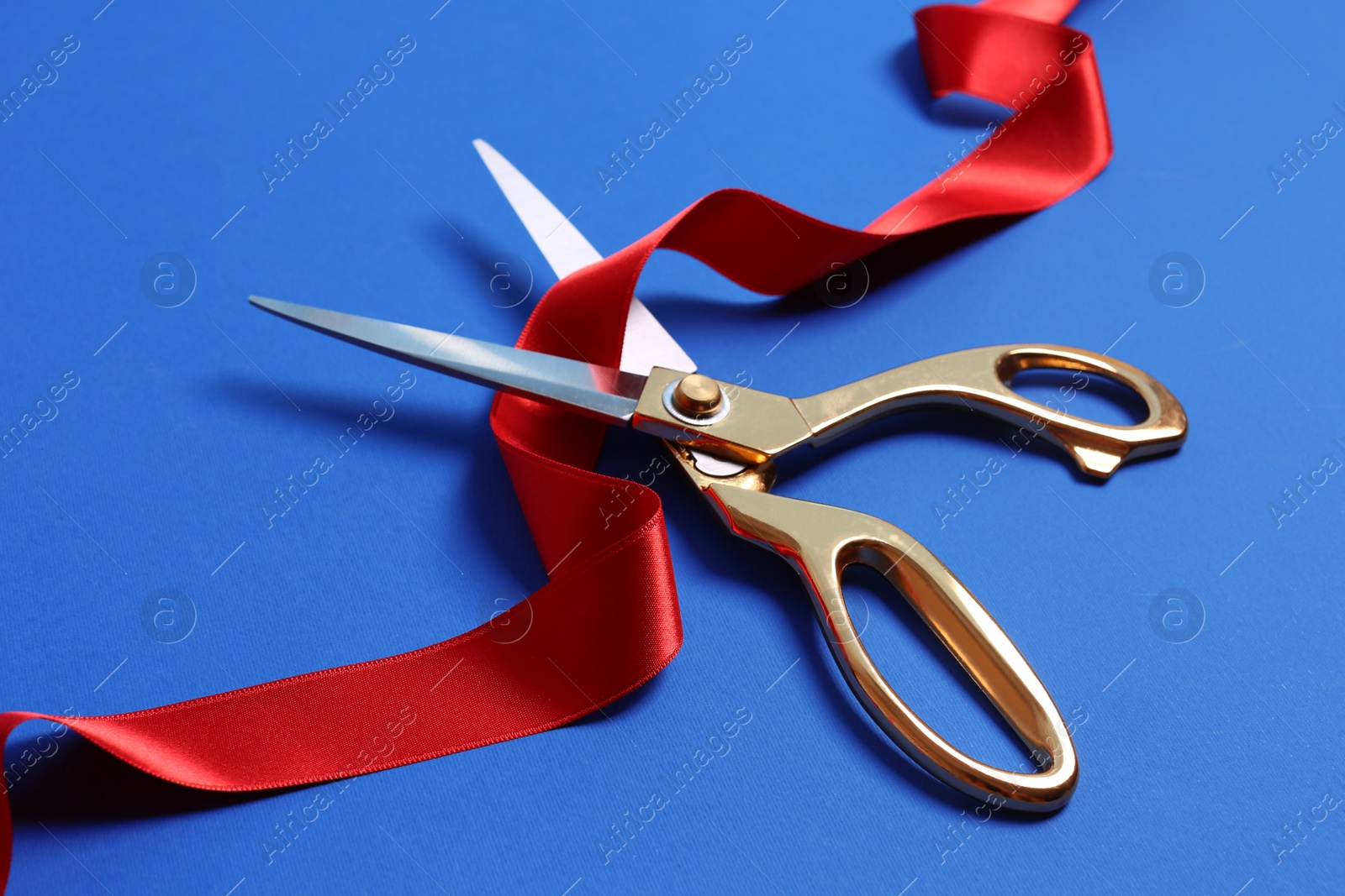 Photo of Ribbon and scissors on color background. Ceremonial red tape cutting