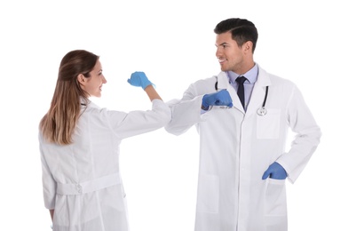 Photo of Doctors greeting each other by bumping elbows instead of handshake on white background