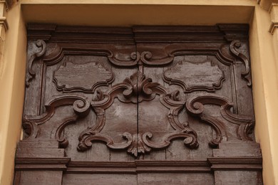 Ornate wooden door of old building, closeup