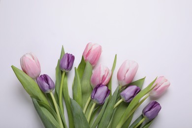 Photo of Beautiful tulips on light background, flat lay. Space for text