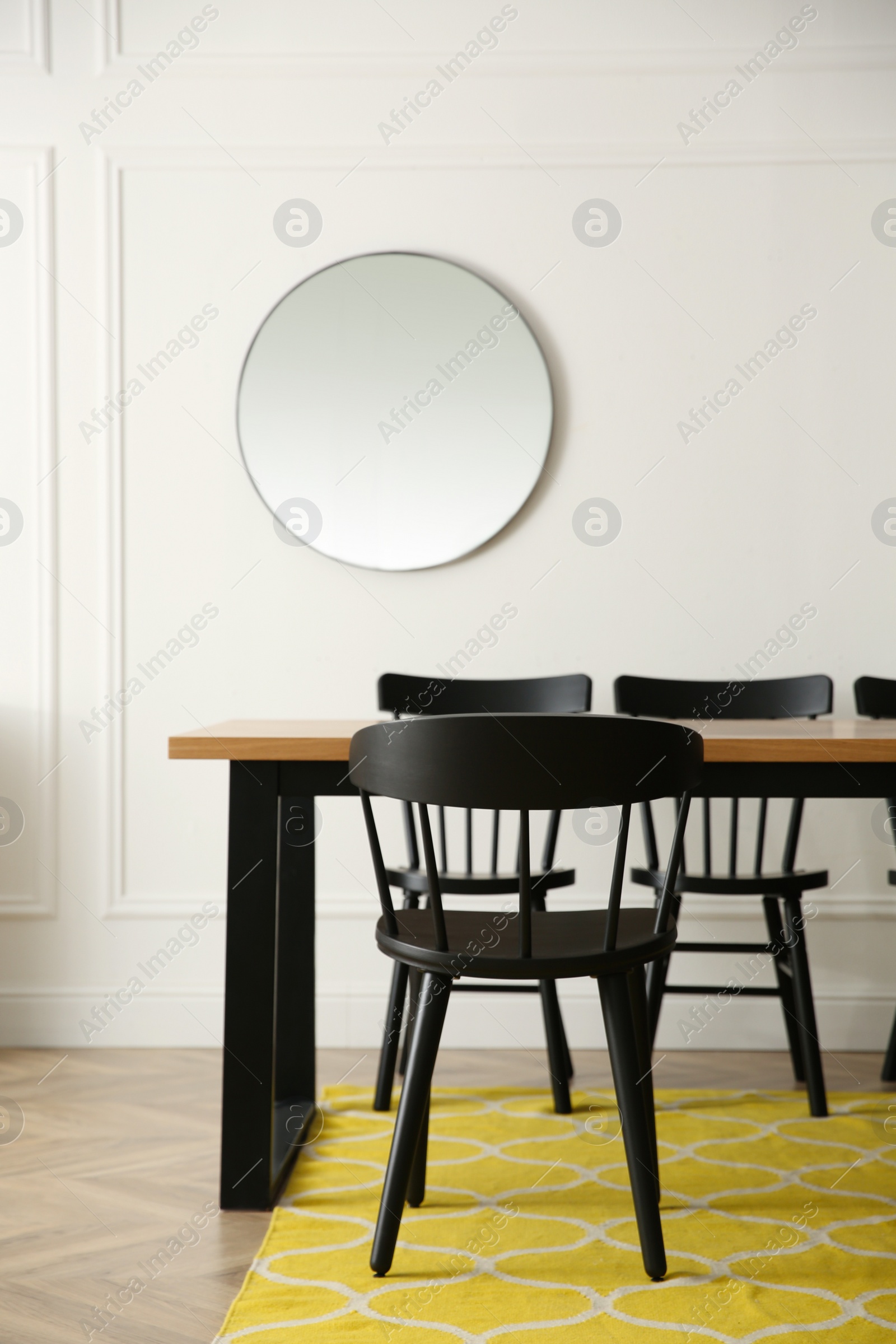 Photo of Stylish wooden dining table and chairs in room. Interior design