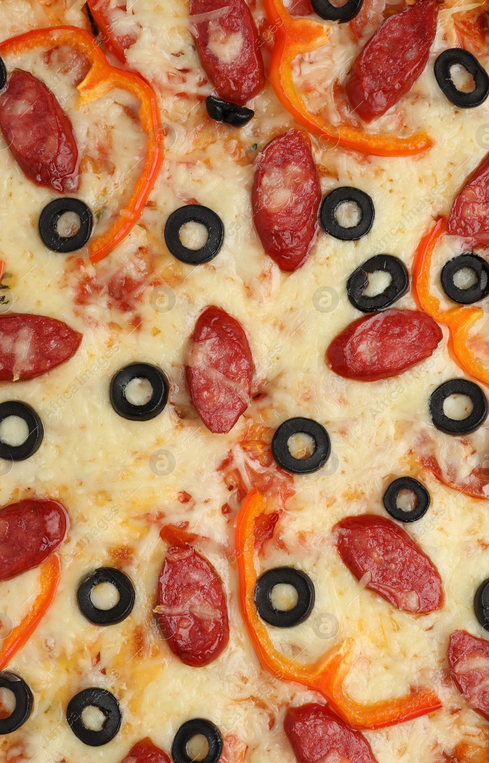 Photo of Tasty pizza with cheese, dry smoked sausages, olives and pepper as background, top view