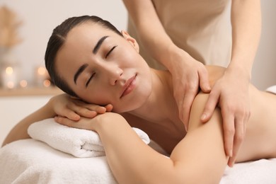 Woman receiving massage on couch in spa salon