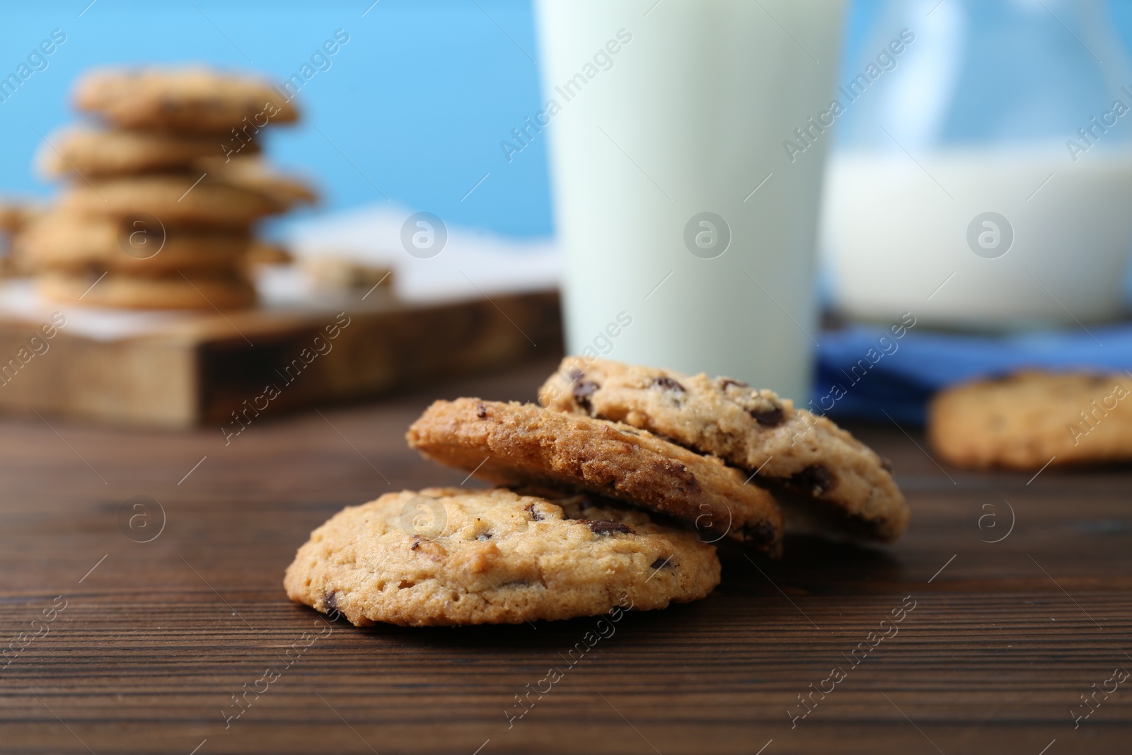 Photo of Delicious chocolate chip cookies on wooden table, closeup