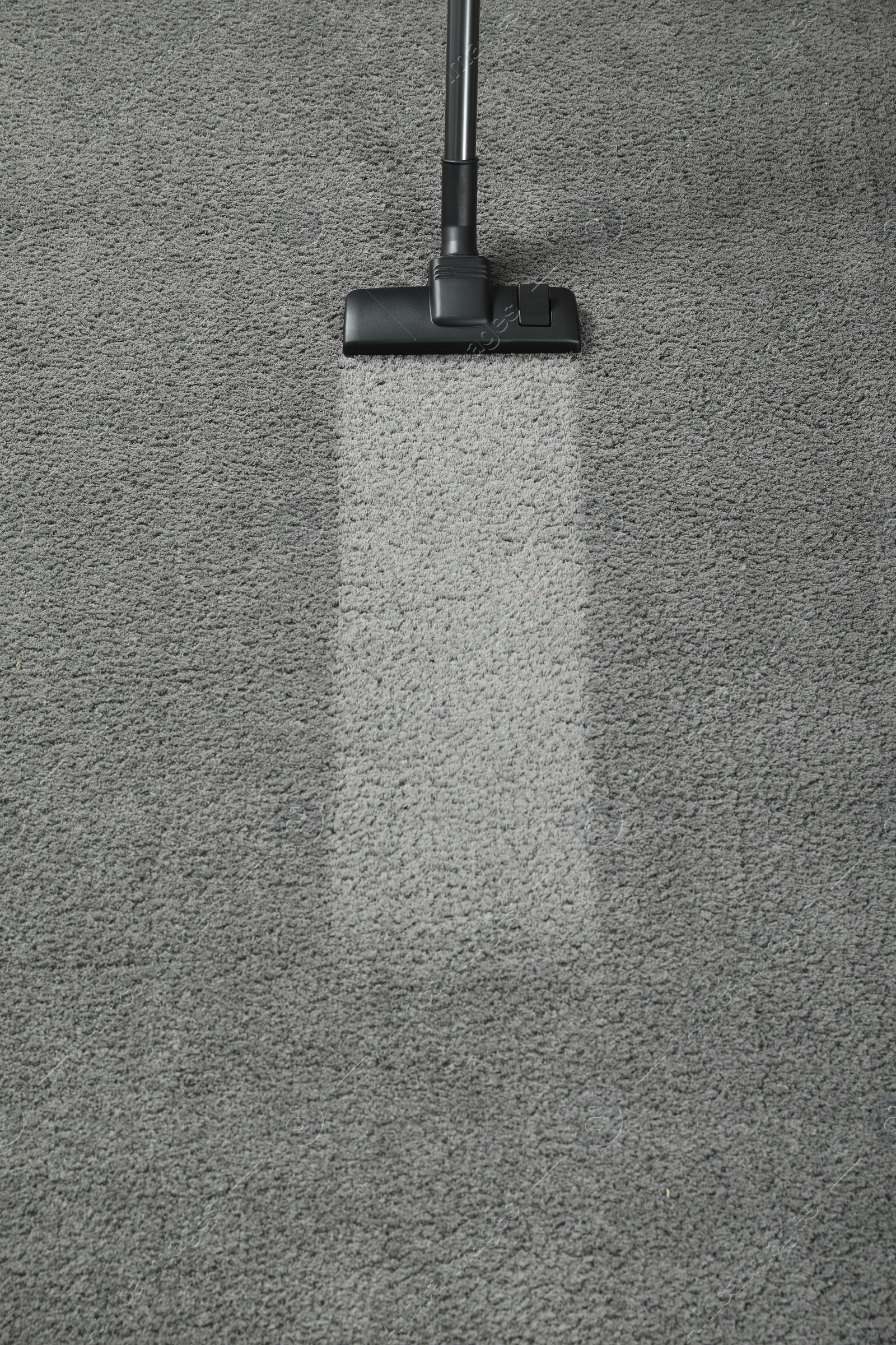 Photo of Vacuuming grey carpet. Clean area after using device, top view. Space for text