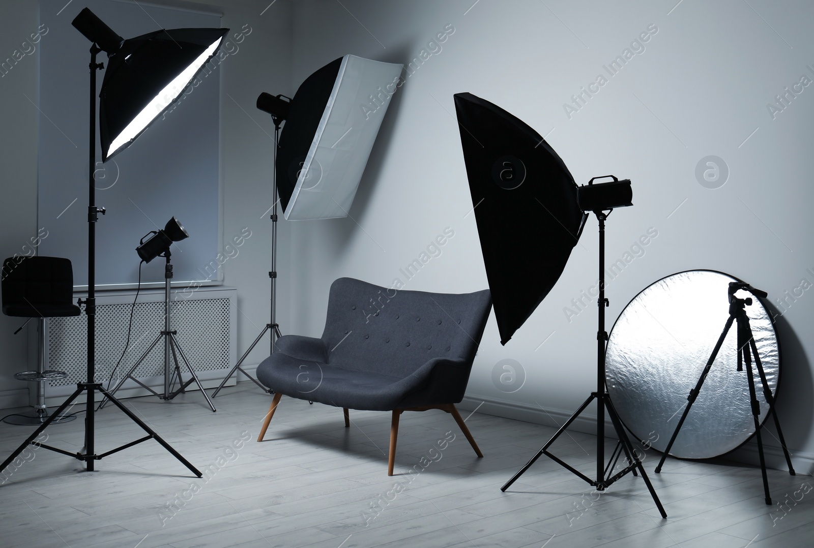 Photo of Modern photo studio with professional lighting equipment