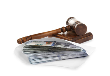 Photo of Envelope with dollar bills and gavel isolated on white. Bribe concept