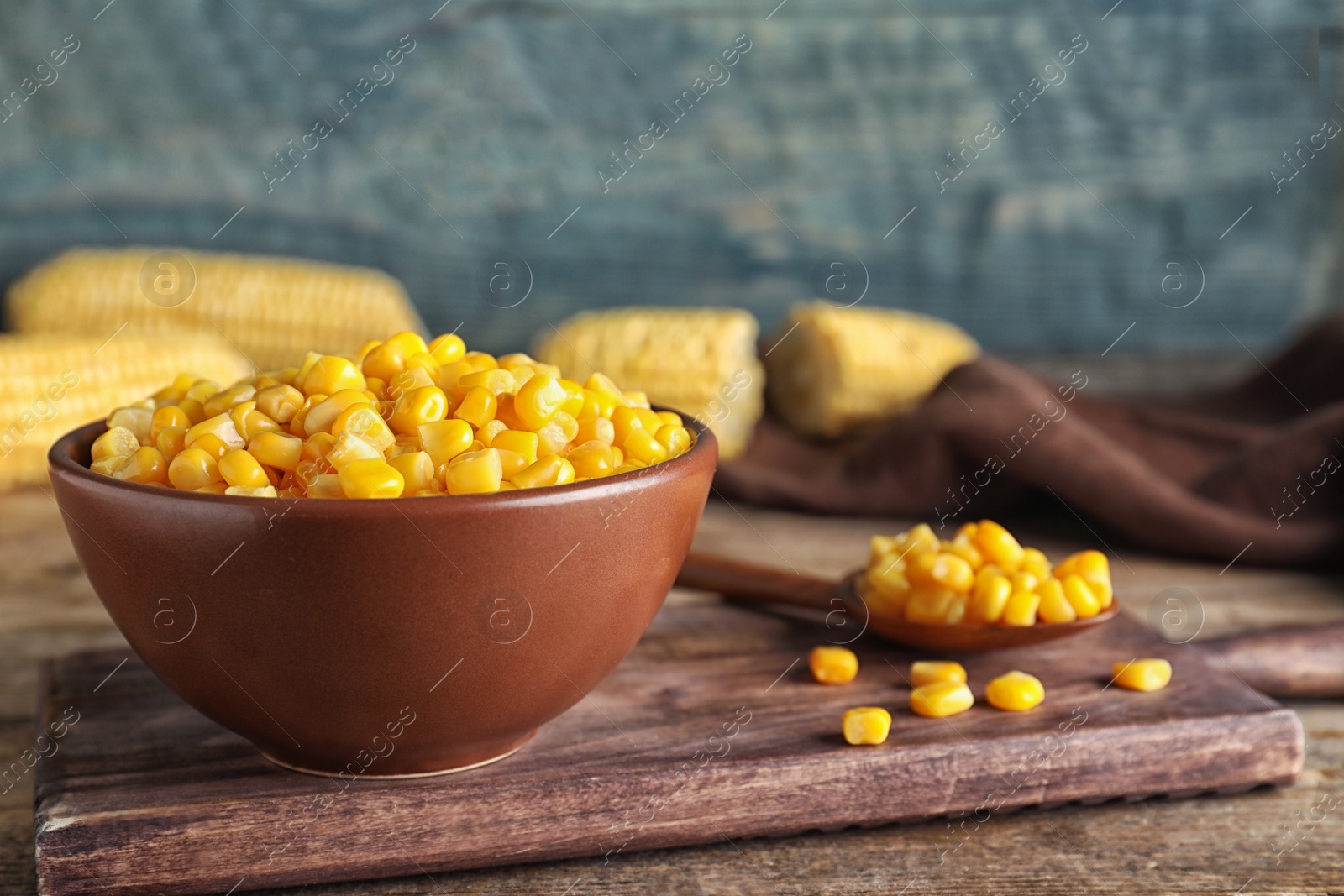 Photo of Delicious canned corn in bowl on wooden table