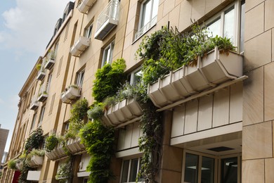 Photo of Exterior of beautiful modern residential building with plants in city