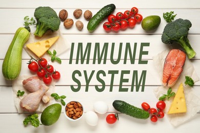 Image of Immune system boosting with proper nutrition. Different foods on white wooden table, flat lay