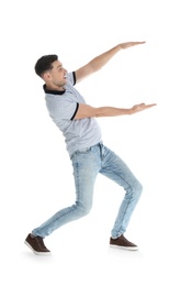 Man in casual clothes holding something on white background