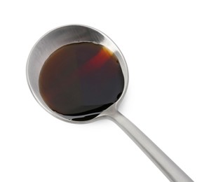 Photo of Tasty soy sauce in spoon isolated on white, above view