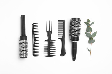 Composition with hair combs and brushes on white background, top view