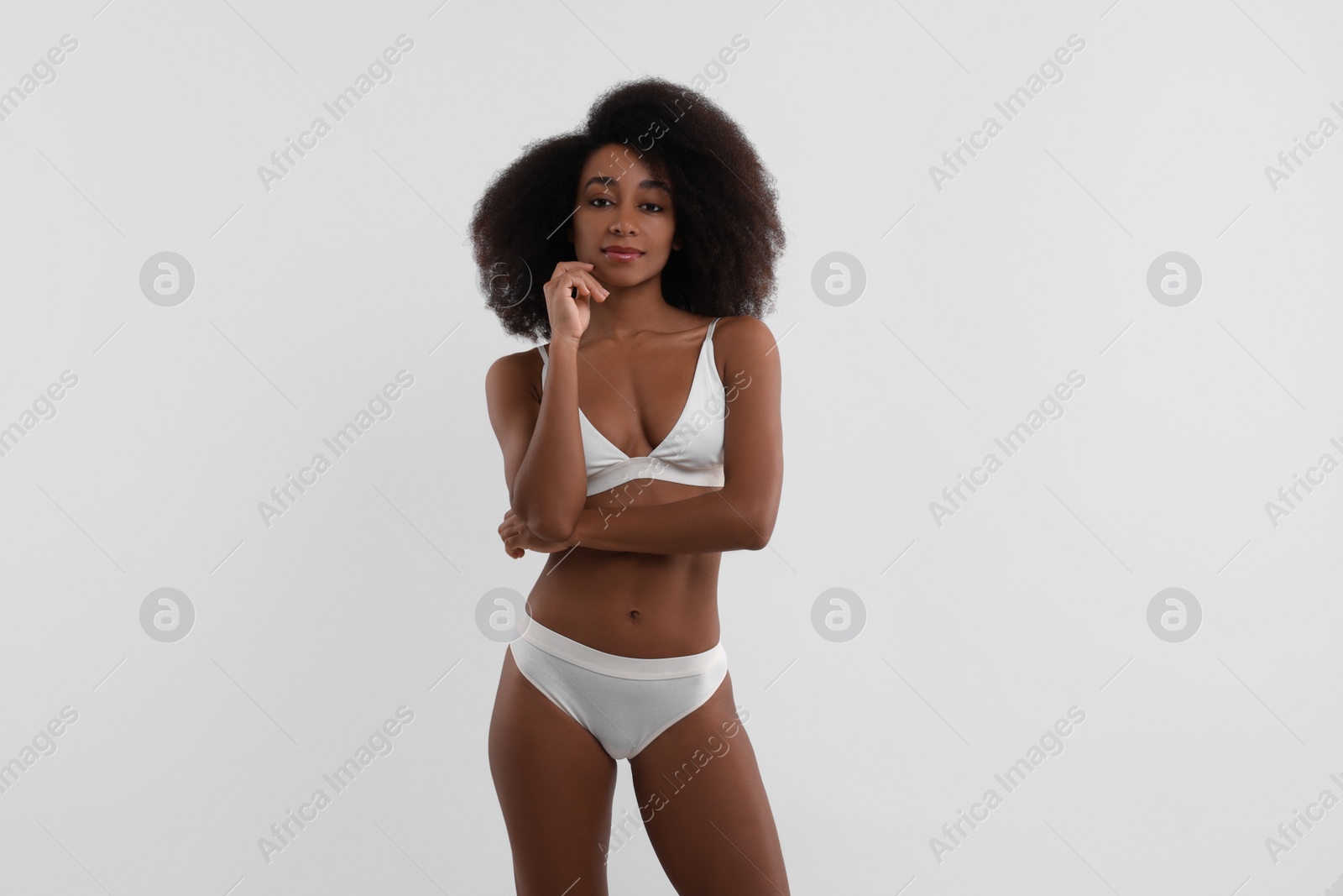 Photo of Beautiful woman in stylish bikini on white background