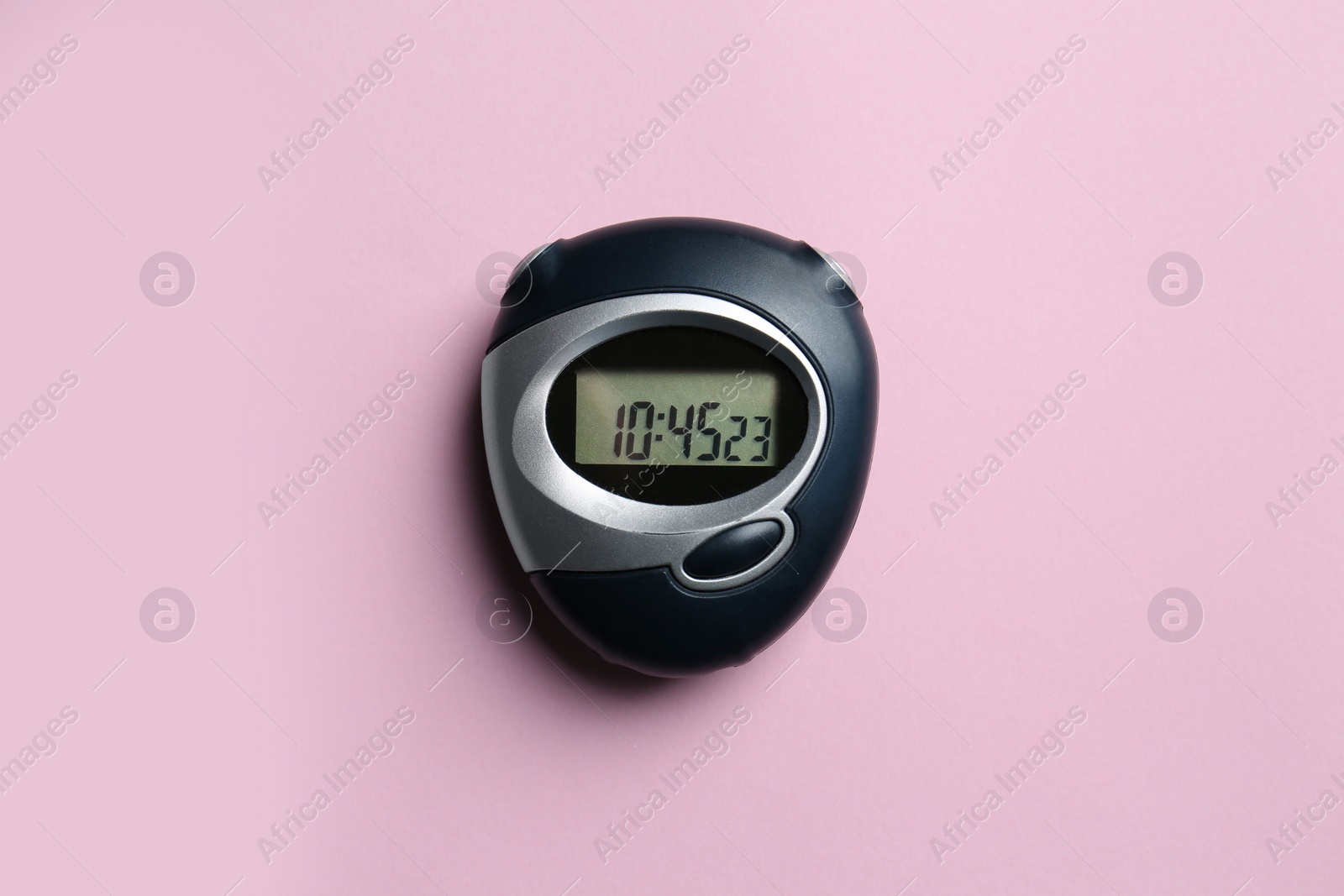 Photo of Digital timer on pink background, top view