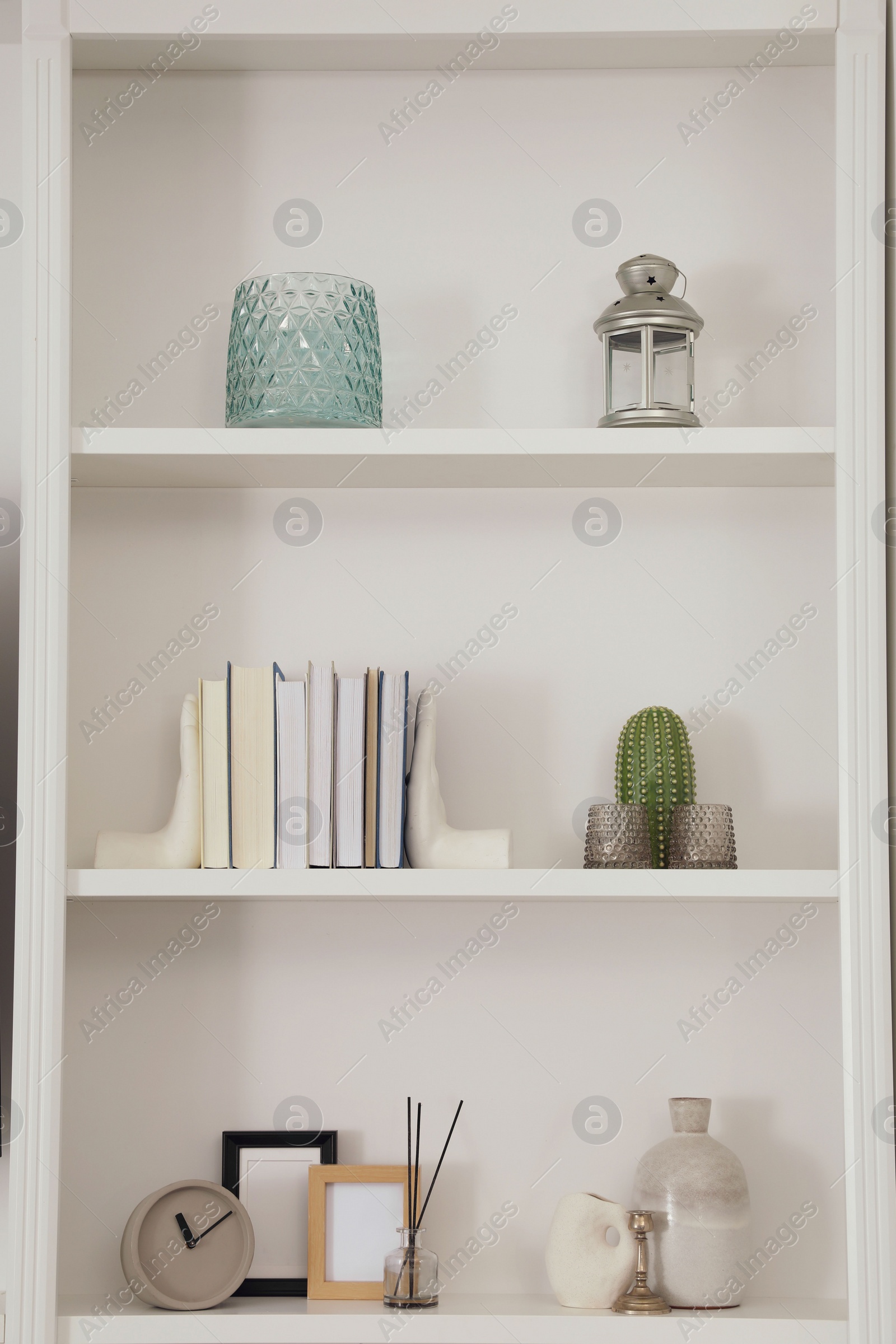 Photo of Stylish shelves with different decor elements. Interior design