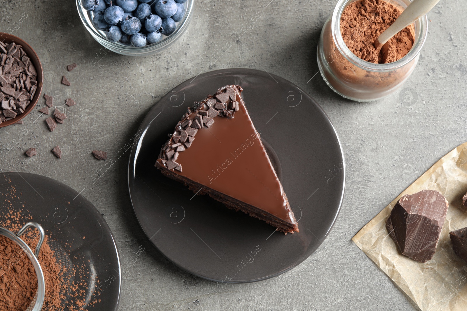 Photo of Delicious fresh chocolate cake served on grey table, flat lay