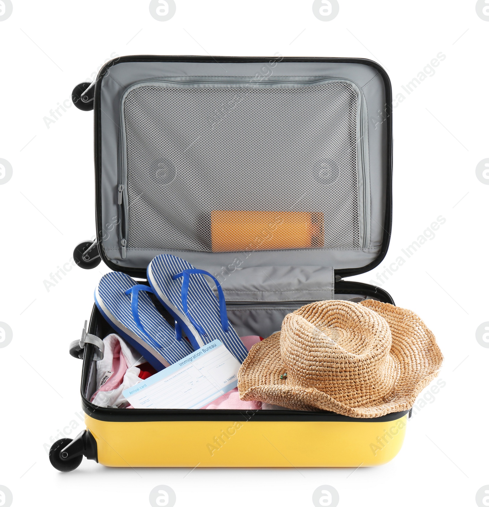 Photo of Packed suitcase with summer clothes and accessories on white background