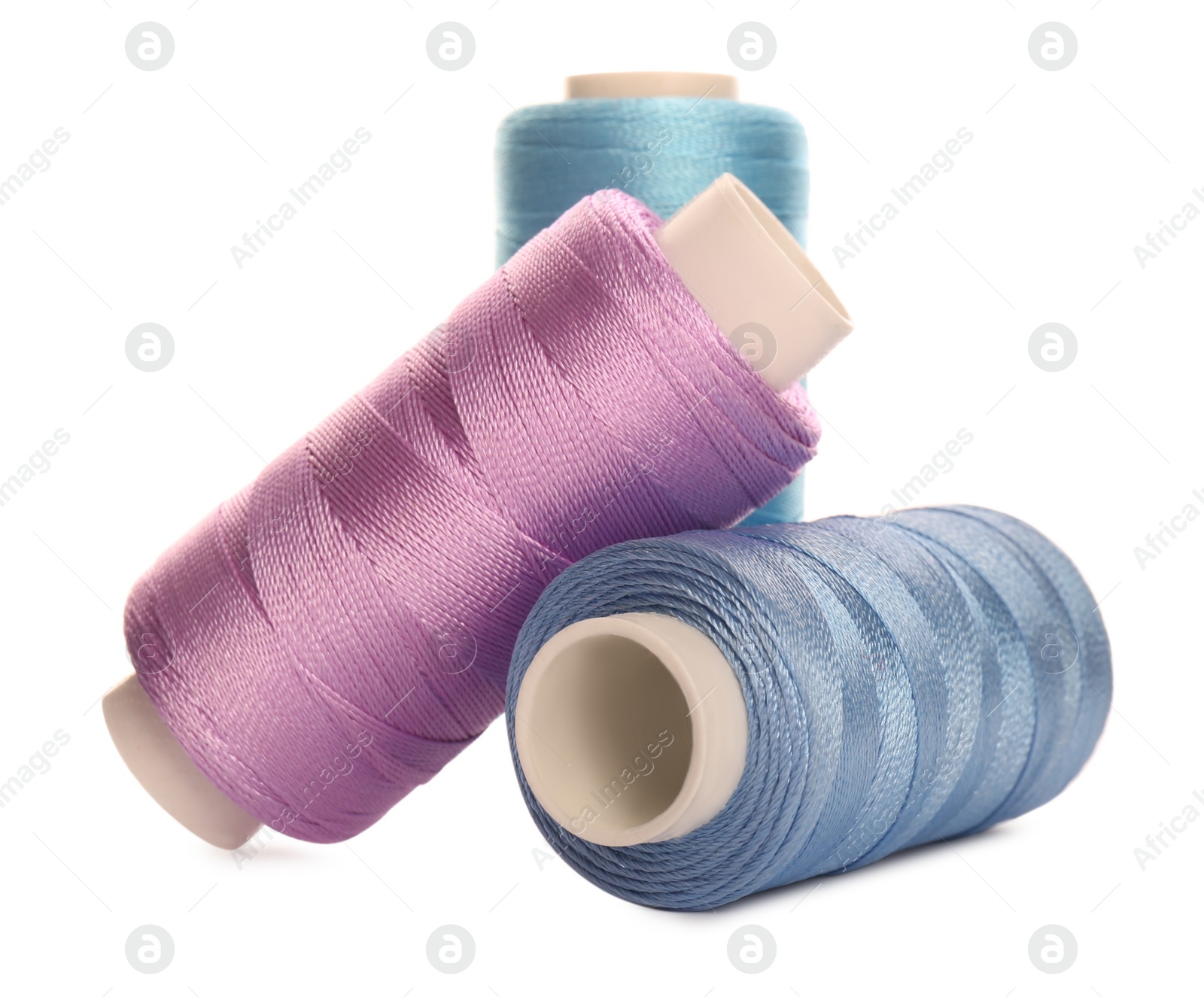 Photo of Different colorful sewing threads on white background