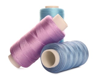 Different colorful sewing threads on white background