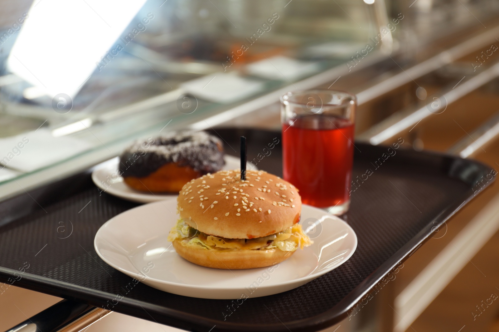 Photo of Plastic tray with tasty food near serving line in school canteen