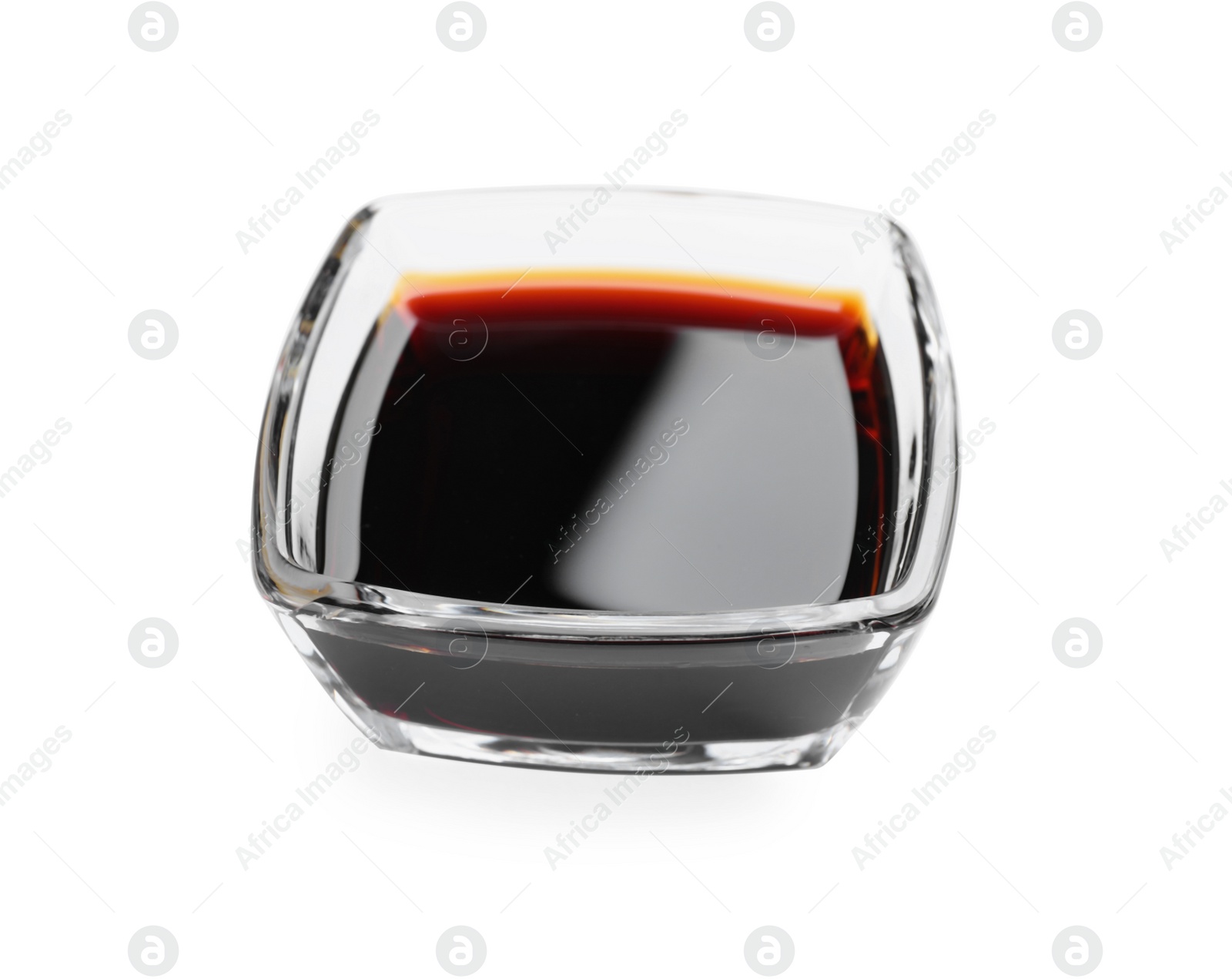 Photo of Bowl of tasty soy sauce isolated on white