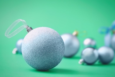 Photo of Many beautiful Christmas balls on green background. Space for text