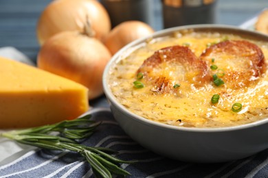 Tasty homemade french onion soup served on table, closeup