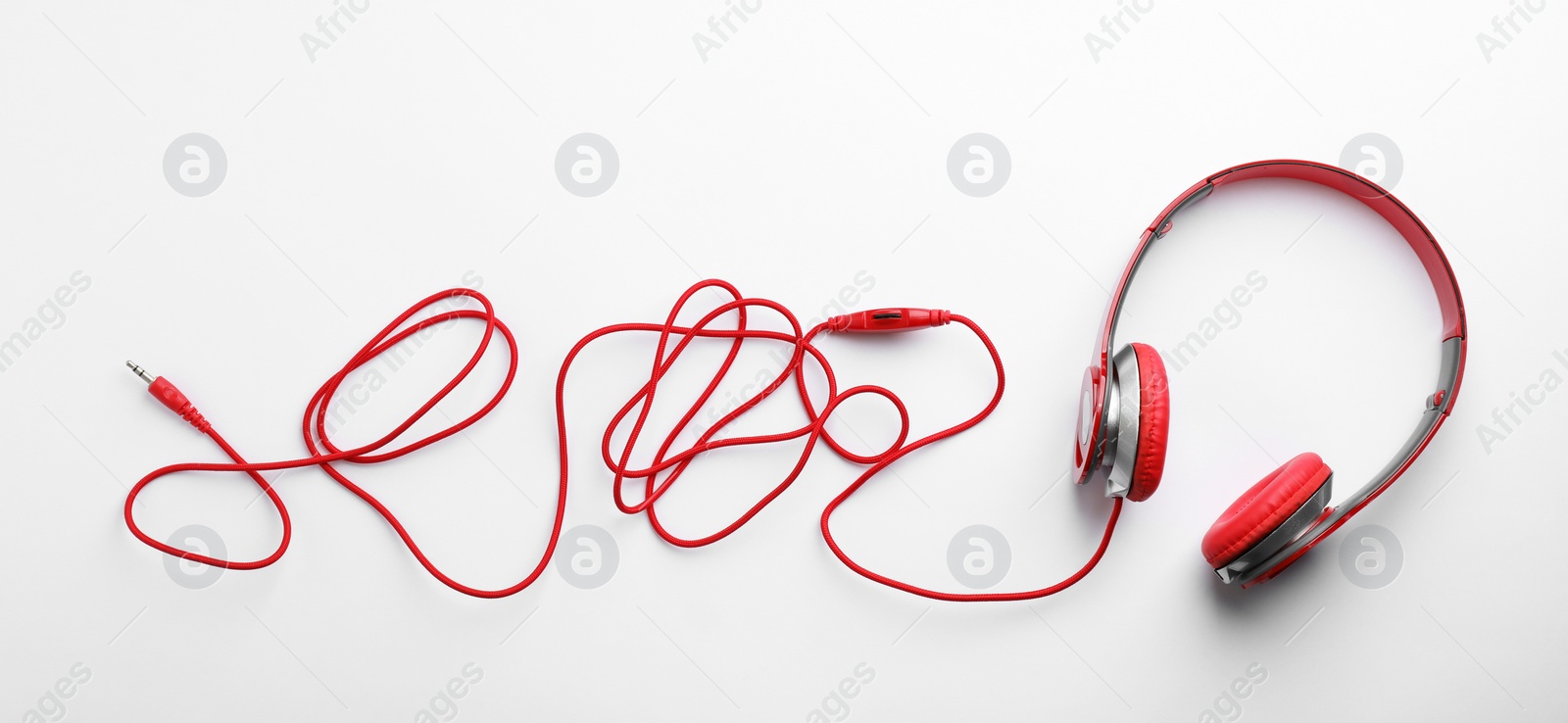 Photo of Stylish modern headphones with earmuffs on white background, top view