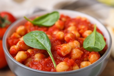 Photo of Delicious chickpea curry with basil in bowl, closeup
