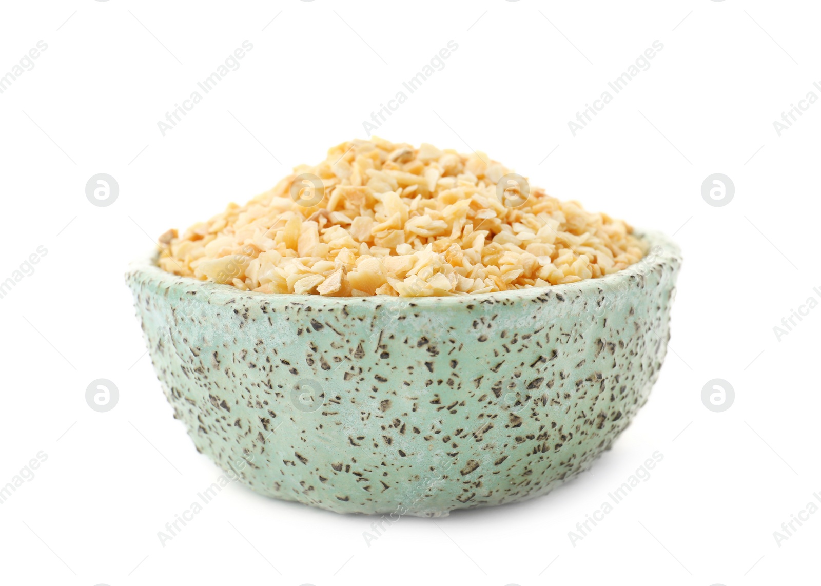 Photo of Bowl of granulated dry garlic on white background