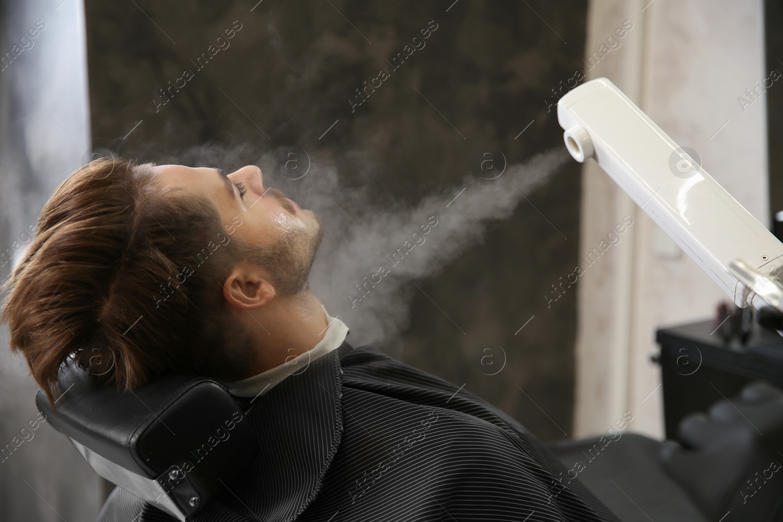 Photo of Hairdresser working with client at barbershop. Professional shaving service