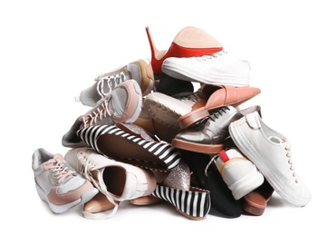 Photo of Pile of different shoes on white background