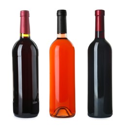 Set with bottles of different delicious expensive wines on white background