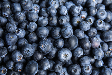 Photo of Fresh tasty blueberries as background, closeup view