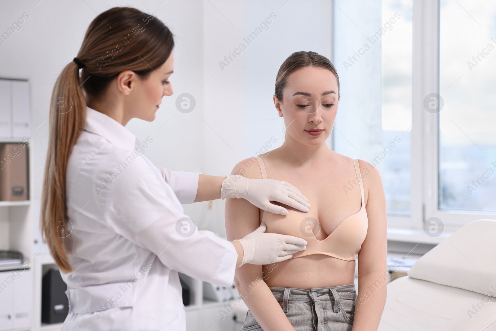 Photo of Mammologist checking young woman's breast in hospital