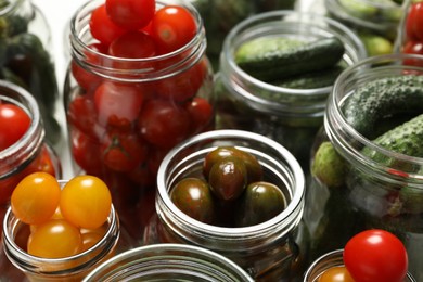 Pickling jars with fresh vegetables, closeup view