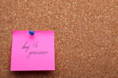 Photo of Pink paper note with phrase Dog To Groomer on cork board. Space for text