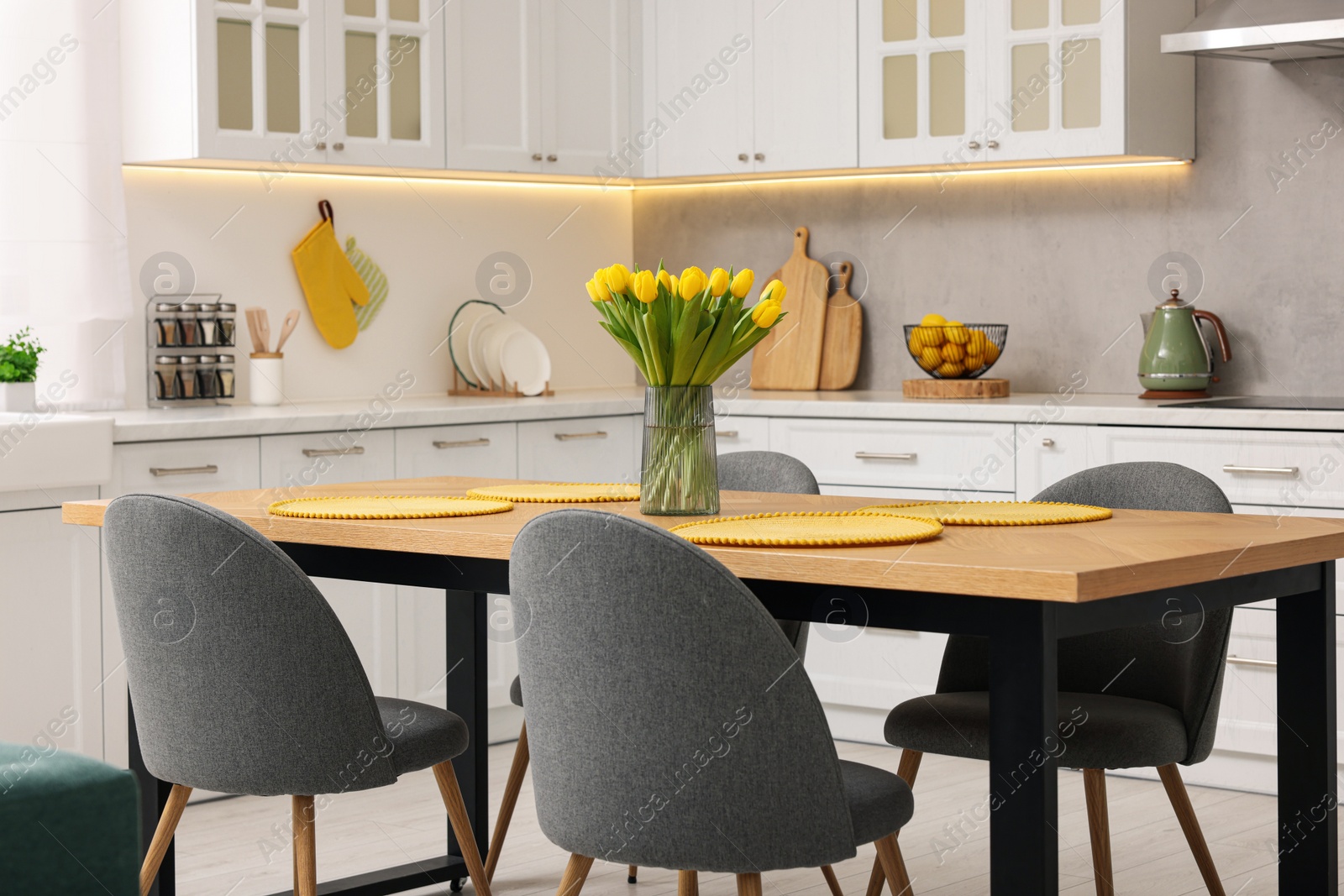 Photo of Spring atmosphere. Stylish kitchen interior with comfortable furniture