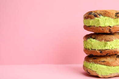 Photo of Sweet delicious ice cream cookie sandwiches on color background, space for text