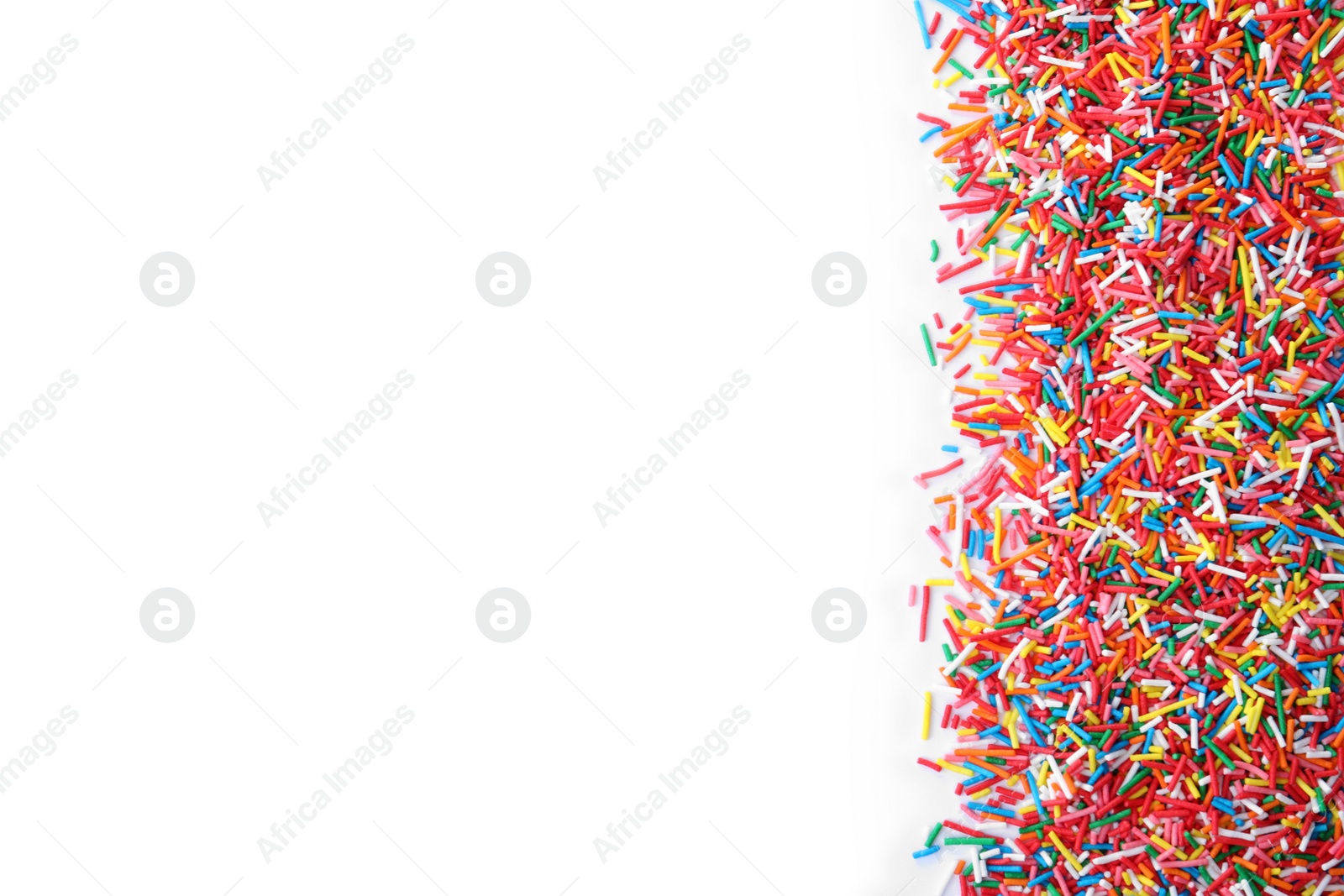 Photo of Colorful sprinkles on white background, top view. Confectionery decor