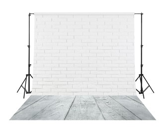 Photo background with white brick wall and wooden floor. Professional studio equipment