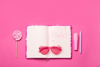 Flat lay composition with word Pink in notebook on color background