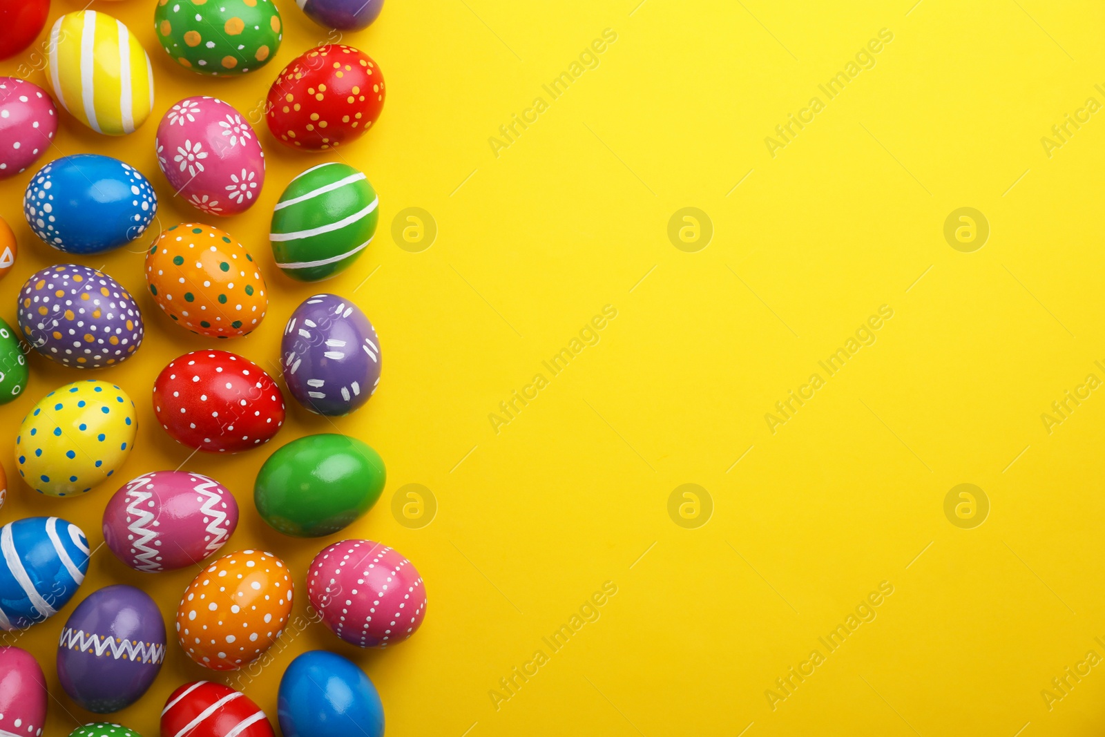 Photo of Decorated Easter eggs and space for text on color background, top view