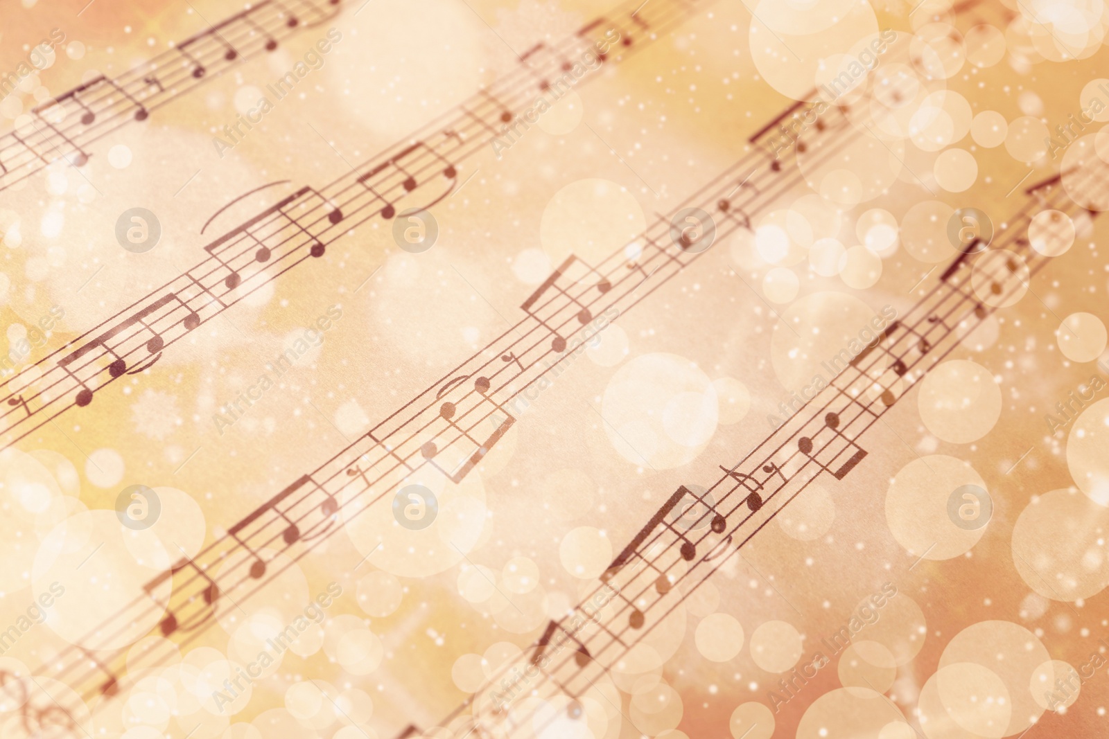 Image of Paper sheet with musical notes, closeup view. Chirstmas song. Bokeh effect
