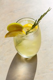 Photo of Tasty refreshing lemonade on light grey table. Summer drink