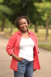 Portrait of happy African-American woman in park