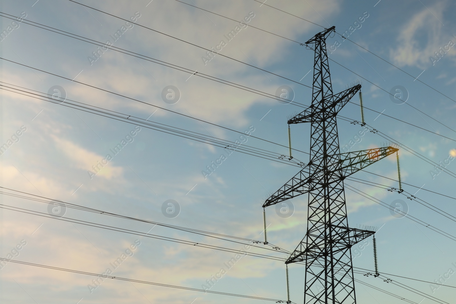 Photo of Telephone pole with cables under blue sky outdoors